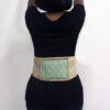 A woman wears a Moxa heat pack.